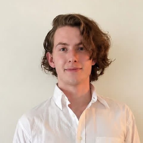 Justin, creator of Investing Horizons, smiling in a white button-down shirt